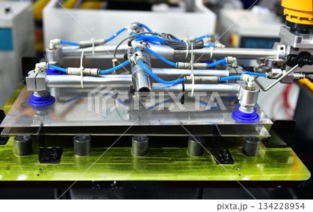 Robot arm control the Steel sheet cutting process in the industrial factory Robot arm control the Steel sheet cutting process in the industrial factory 134228954