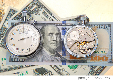 mechanical stopwatch on the background of dollars. Part time accuracy for business. 134229665
