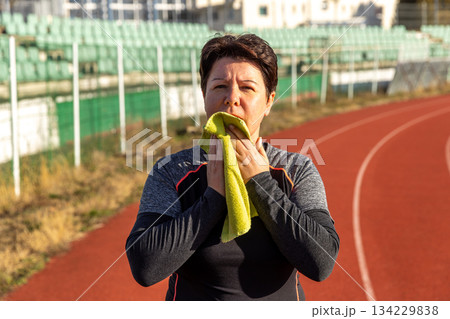 Woman drying face with a towel 134229838