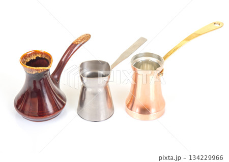 A set of three Turkish coffee pots in stainless steel, glazed ceramic A set of three Turkish coffee pots in stainless steel, glazed ceramic 134229966