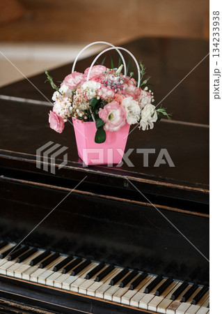 Flower Basket on Elegant Black Piano Flower Basket on Elegant Black Piano 134233938