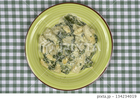 Gnocchi with creamy spinach sauce 134234019