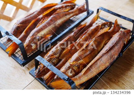 Freshly grilled fish displayed on serving trays 134234396