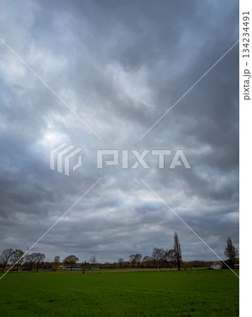 Rijkevorsel, Antwerpse Kempen, Belgium, Gloomy clouds over open field and distant church steeple Rijkevorsel, Antwerpse Kempen, Belgium, Gloomy clouds over open field and distant church steeple 134234491