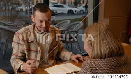Two young people talking, emphasizing a point with a hand gesture Two young people talking, emphasizing a point with a hand gesture 134234705