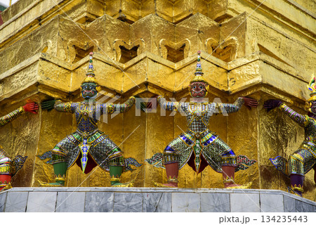 The gold statues of the four-armed figures are on a building 134235443