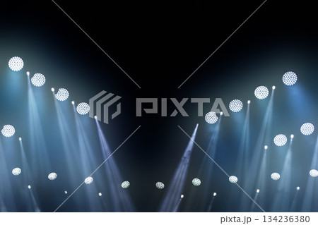 Stage white beams of light on dark blue background. Stage lighting for a concert. Stage white beams of light on dark blue background. Stage lighting for a concert. 134236380