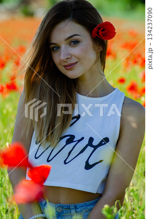 pretty woman in the field of poppies pretty woman in the field of poppies 134237090