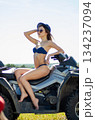 Sexy, slim, pretty, attractive girl in swimsuit on the ATV quad bike. ATV concept. 134237094