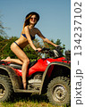 Sexy, slim, pretty, attractive girl in swimsuit on the ATV quad bike. ATV concept. 134237102