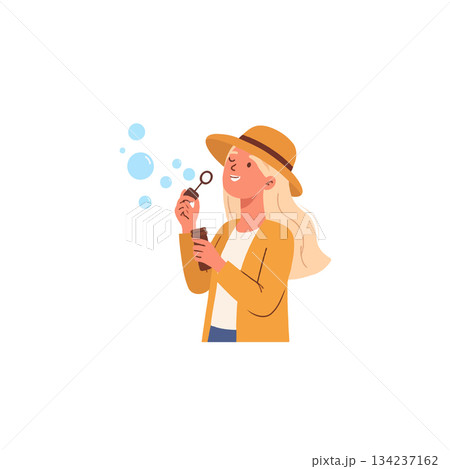 A lighthearted moment: Blonde woman enjoys creating soap bubbles on a sunny afternoon a refreshing 134237162