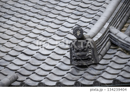 This Japanese traditional Onigawara features a fierce guardian face believed to ward off evil spirits 134239404