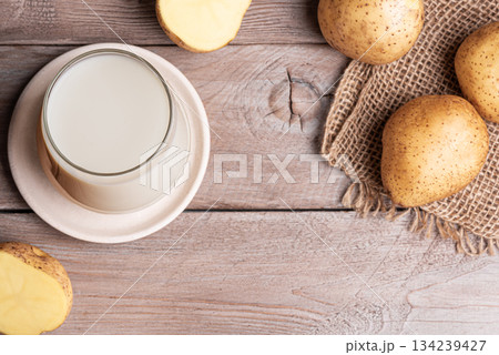 Vegan potato milk on wooden background Vegan potato milk on wooden background 134239427