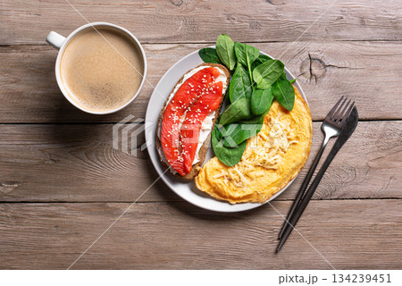 Healthy breakfast for two. Omelette, sandwich with salmon, spinach. Healthy breakfast for two. Omelette, sandwich with salmon, spinach. 134239451