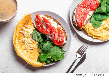 Healthy breakfast. Omelette, sandwich with salmon, spinach. Healthy breakfast. Omelette, sandwich with salmon, spinach. 134239518