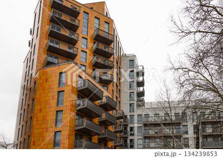 Modern Orange Apartment Building Facade with Balconies 134239853