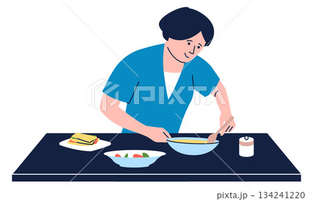 A woman is cooking food on a table A woman is cooking food on a table 134241220