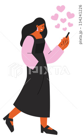 A woman is walking and holding a cell phone 134241226