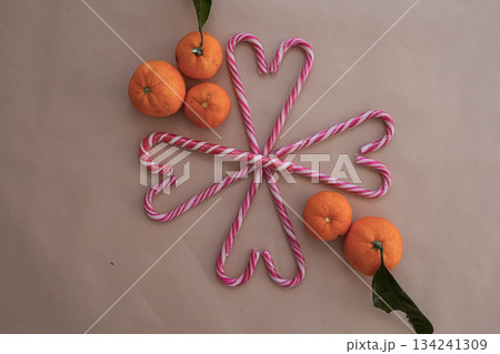 Tangerines and Heart Candy Canes on Neutral Background 134241309