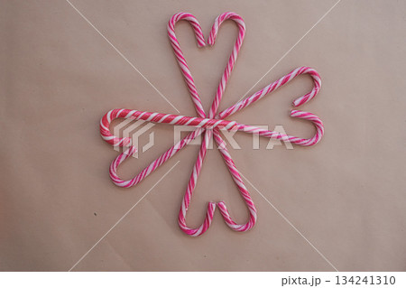 Heart-Shaped Candy Canes on Beige Background with Decorative Pattern 134241310