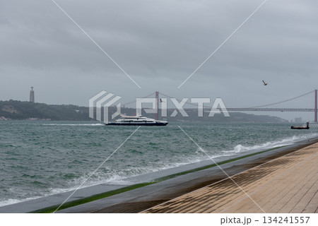 Bridge across blue bay to city beyond Lisbon panorama Portugal Bridge across blue bay to city beyond Lisbon panorama Portugal 134241557