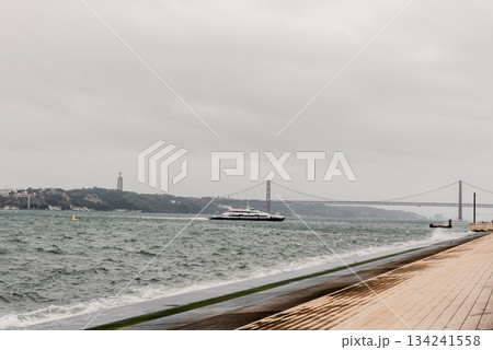 Bridge across blue bay to city beyond Lisbon panorama Portugal 134241558