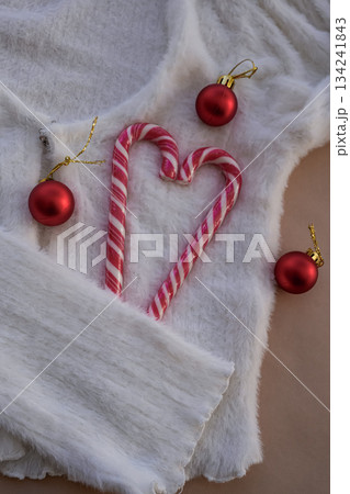 Heart Candy Cane on White Sweater with Red Christmas Ornaments 134241843