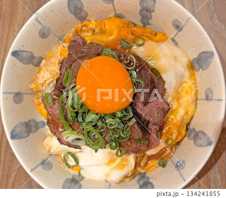 Gourmet beef and egg rice bowl with fresh scallions and rich sauce Gourmet beef and egg rice bowl with fresh scallions and rich sauce 134241855