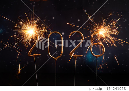 Sparkling New Year 2026. Glowing sparklers forming the number 2026 against a starry night sky 134241928