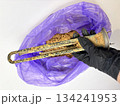 Plumber hand holding a boiler heating element covered with limescale, hard water residue, boiler maintenance and cleaning, scale removal, water heater repair 134241953