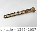 Boiler heating element covered with hard water limescale on white background, damaged heater element, scale buildup concept 134242037