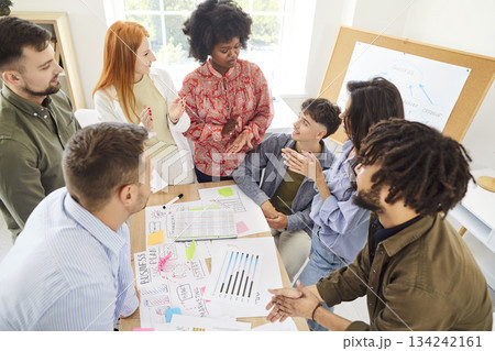 Team of young creative people is working on a business marketing project together Team of young creative people is working on a business marketing project together 134242161