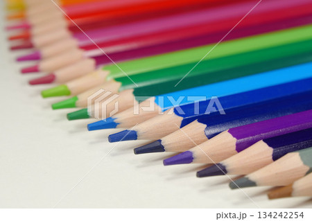 New wooden colored pencils of rainbow colors, perfectly sharpened, lie on table New wooden colored pencils of rainbow colors, perfectly sharpened, lie on table 134242254