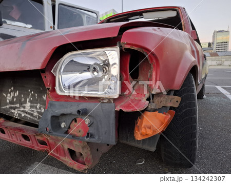 Red car after an accident. Passenger car in wreck condition after road accident 134242307
