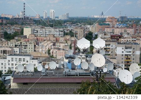 Satellite dishes on house roof 134242339