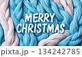 Merry Christmas greeting on blue and pink wool yarn background for holiday card design or banners for knitting stores and blogs 134242785