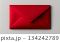 Bright red envelope isolated on light gray background. Invitations, special occasions, festive messages concept 134242789