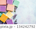 Colorful handmade soaps with lavender flowers on pastel background with copyspace. Spa, beauty, hobby themes 134242792