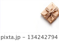 Top view of gift paper wrapping with brown bow isolated on white. Minimalist background with em[ty space for holiday, sale, shopping theme 134242794