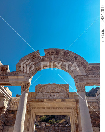 Hadrian's gate at ephesus, towering roman ruins with ornate columns and reliefs under a bright blue sky, a monumental archaeological landmark and popular tourist site Hadrian's gate at ephesus, towering roman ruins with ornate columns and reliefs under a bright blue sky, a monumental archaeological landmark and popular tourist site 134242816