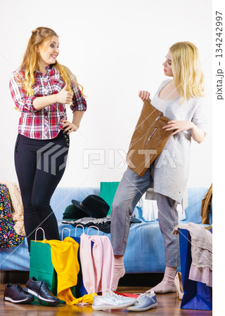 Two happy female friends after shopping 134242997