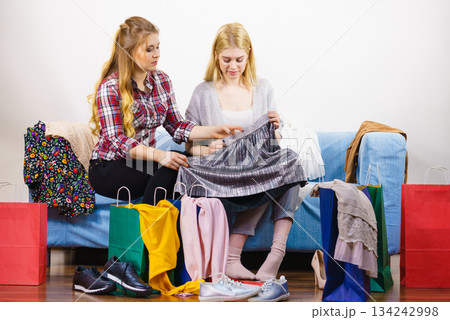 Two unhappy female friends after shopping Two unhappy female friends after shopping 134242998