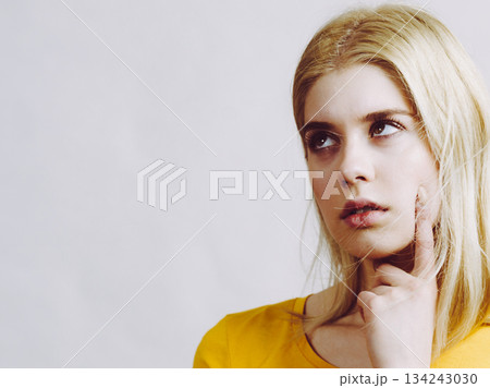 Young woman thinking seeks solution. 134243030