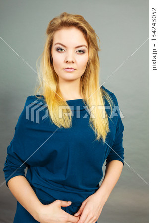 Portrait blonde young woman having serious face expression 134243052