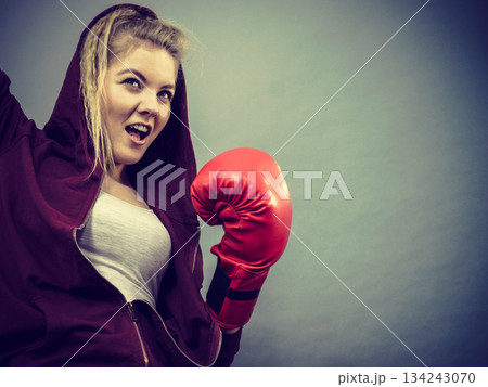 Woman winner wearing boxing gloves Woman winner wearing boxing gloves 134243070