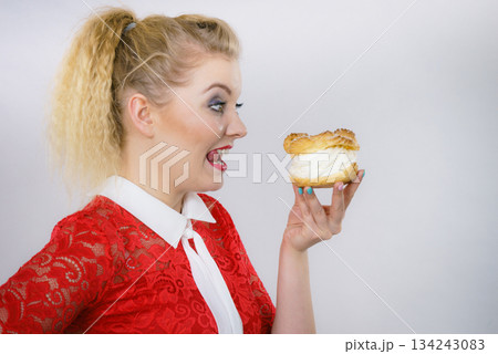 Woman holding cupcake dessert with cream Woman holding cupcake dessert with cream 134243083