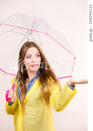 Woman in rainproof coat with umbrella. Forecasting 134243115
