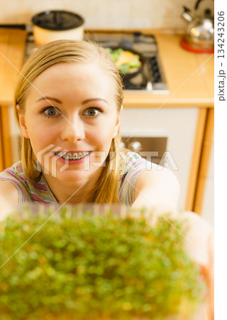 Happy woman holding cuckooflower cress 134243206