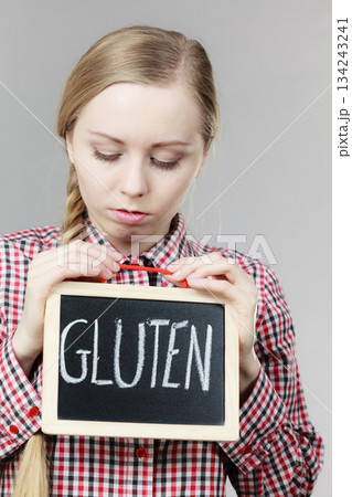 Angry woman holding board with gluten sign 134243241