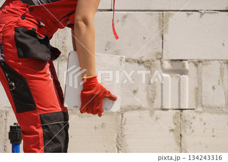 Woman working with bricks 134243316